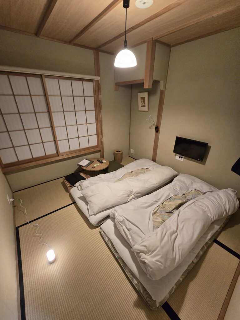 habitación tradicional japonesa (washitsu) con suelo de tatami y futones extendidos para dormir.